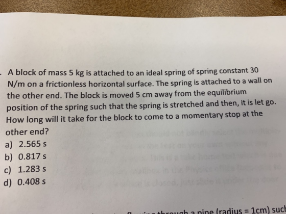 A block of mass 5 kg is attached to an ideal spring of spring constant 30 N/m on a frictionless horizontal surface. The sprin