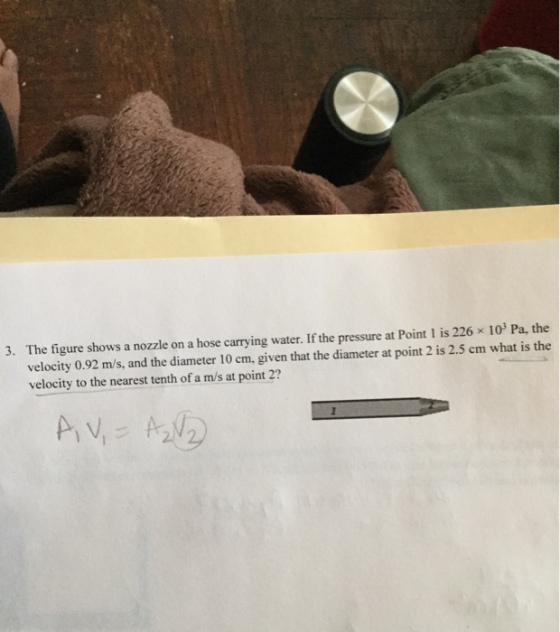 The figure shows a nozzle on a hose carrying water. If the pressure at Point l is 226 × 103 Pa, the velocity 0.92 m/s, and the diameter 10 cm, given that the diameter at point 2 is 2.5 cm what is the velocity to the nearest tenth of a m/s at point 2? 3.