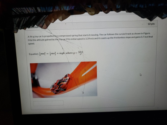 10 pts gestion A 96-g toy car is propelled by a compressed spring that starts it moving. The car follows the curved track as