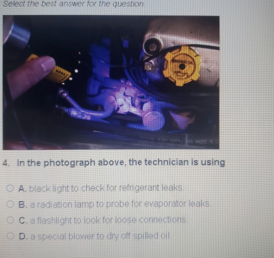 Select the best answer for the question 4. In the photograph above, the technician is using O A. black light to check for ref