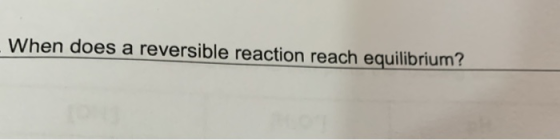 When does a reversible reaction reach equilibrium?