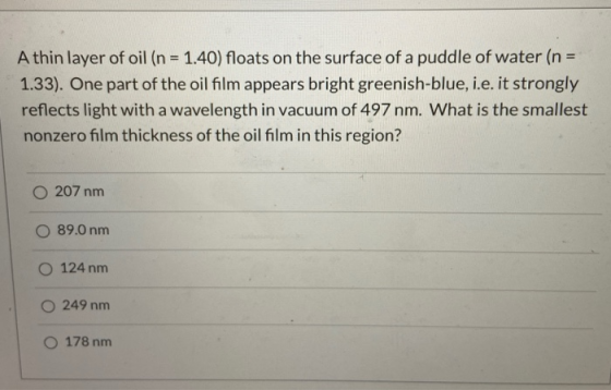 A thin layer of oil (n = 1.40) floats on the surface of a puddle of water (n = 1.33). One part of the oil film appears bright